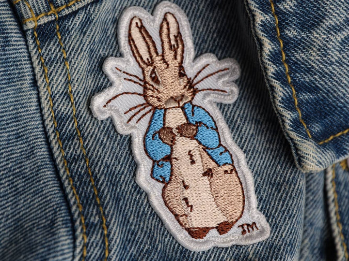 Peter Rabbit embroidered patch on the front of a denim jacket